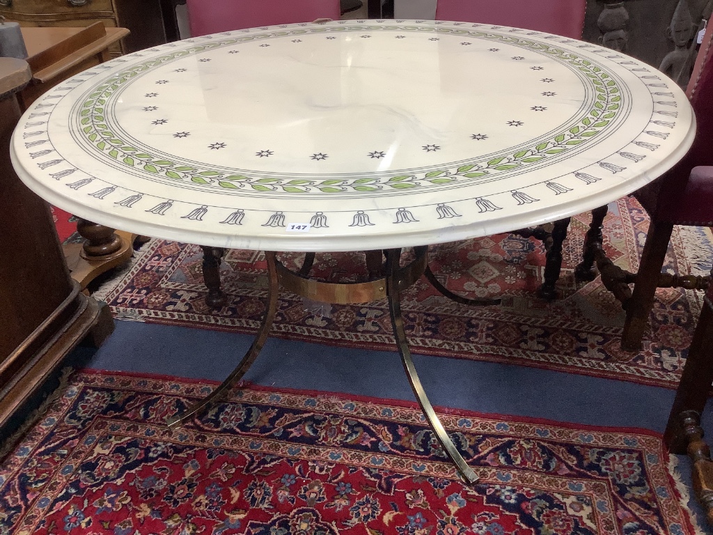 A modern circular dining table, with faux marble top on gilt metal base with splayed legs, diameter 134cm height 72cm